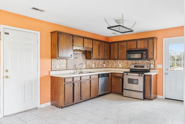 kitchen with backsplash, sink, and stainless steel appliances