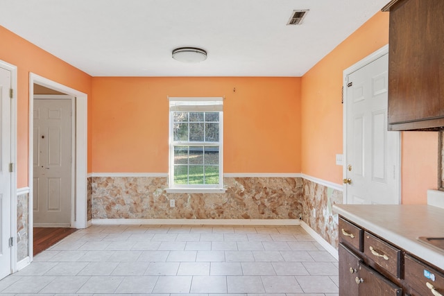 unfurnished dining area featuring light tile patterned floors