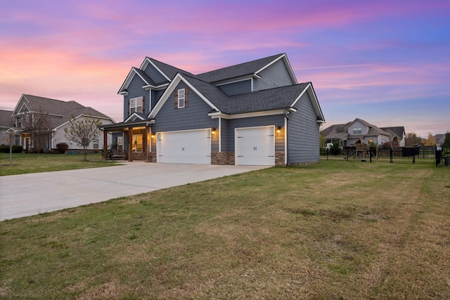 craftsman house with a yard and a garage