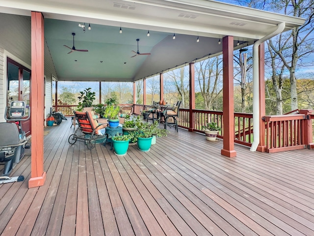 wooden deck featuring ceiling fan