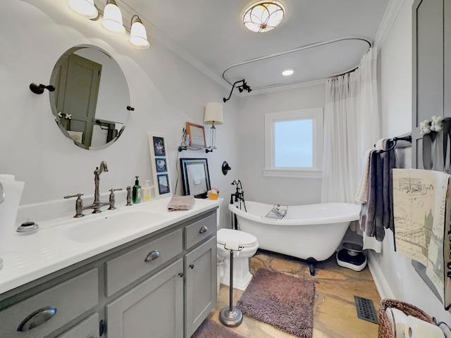 bathroom featuring a bathtub, toilet, crown molding, and vanity