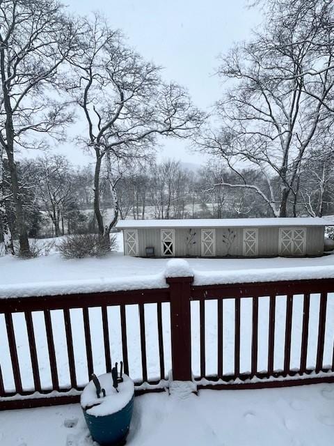 view of snow covered back of property