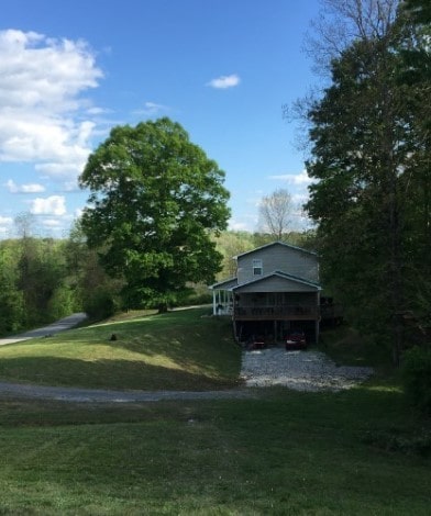 view of front of house with a front yard and a wooden deck