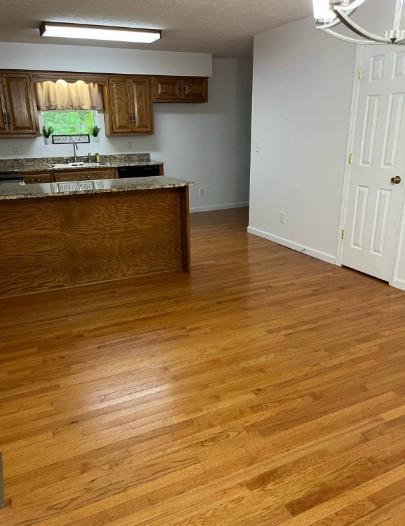 1159 New Hope Rd, Celina, TN 38551 - kitchen featuring light wood-type flooring, a sink, baseboards, and a chandelier