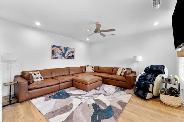 living room with hardwood / wood-style flooring and ceiling fan