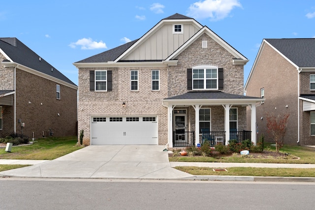 view of front facade featuring a front yard, a garage, and a porch