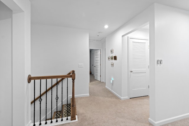 hall featuring light colored carpet