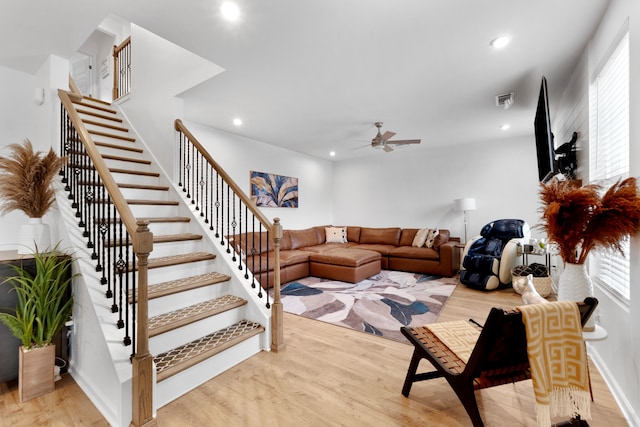 living room with ceiling fan and light hardwood / wood-style floors