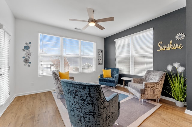 living area featuring ceiling fan and light hardwood / wood-style floors