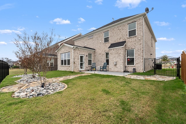 back of house with a patio area and a yard