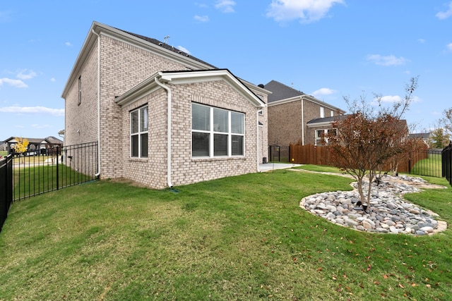 rear view of property with a lawn