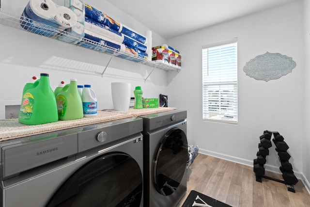 washroom featuring light hardwood / wood-style floors and washing machine and clothes dryer