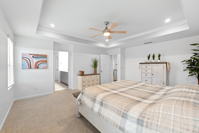 carpeted bedroom featuring ceiling fan, connected bathroom, and a tray ceiling