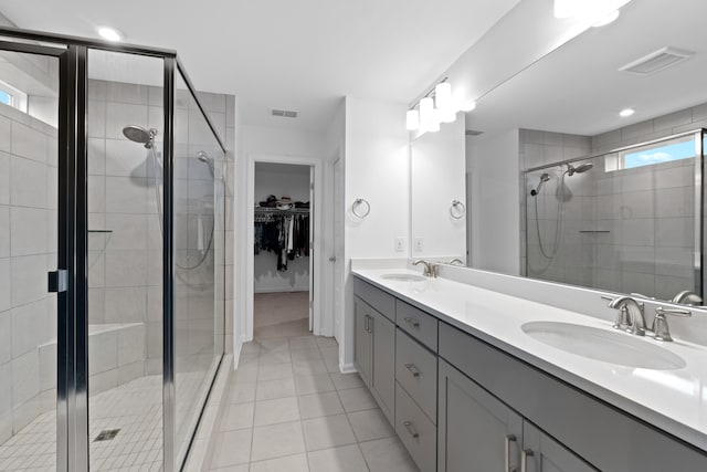 bathroom featuring an enclosed shower, vanity, and tile patterned floors