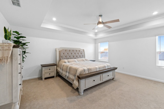 carpeted bedroom featuring ceiling fan, a raised ceiling, and multiple windows