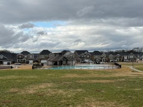 view of pool featuring a lawn