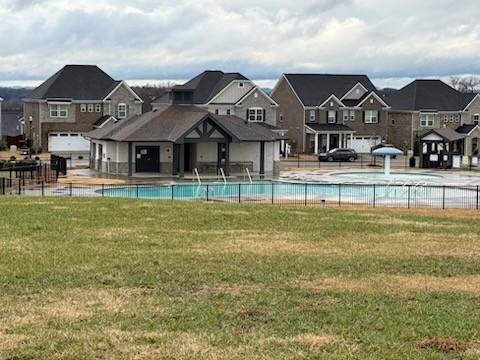 view of swimming pool featuring a yard