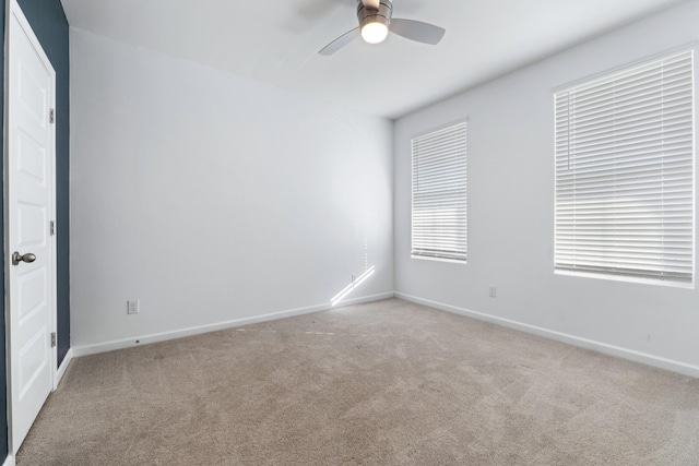 carpeted empty room featuring ceiling fan