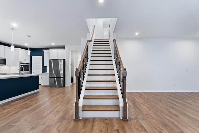 stairs with wood-type flooring