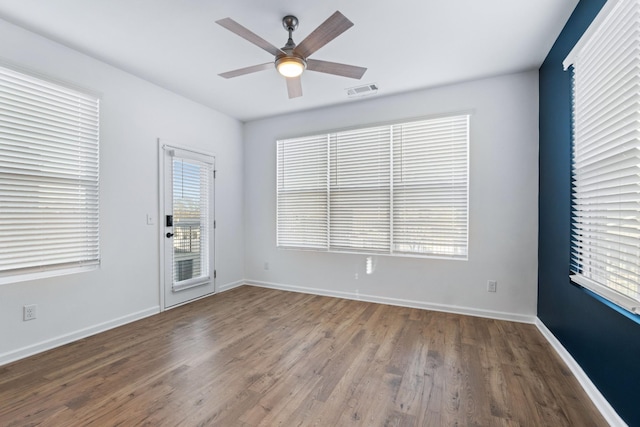 spare room featuring ceiling fan and hardwood / wood-style flooring