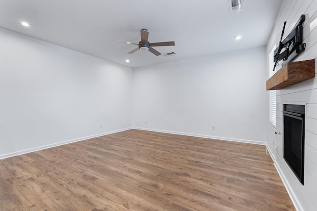 unfurnished living room with ceiling fan and light hardwood / wood-style flooring