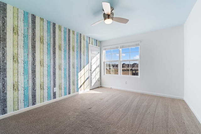 carpeted empty room featuring ceiling fan