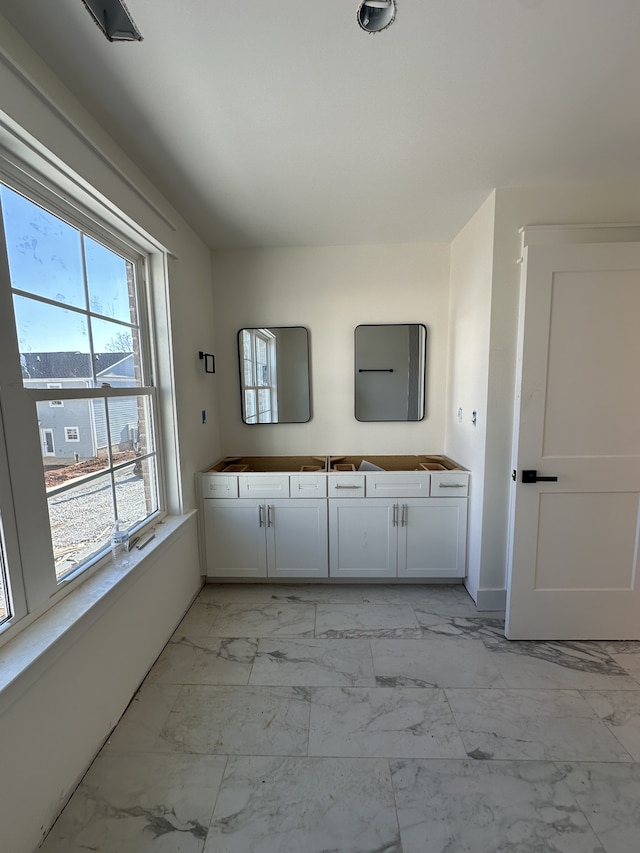 bathroom with plenty of natural light and vanity