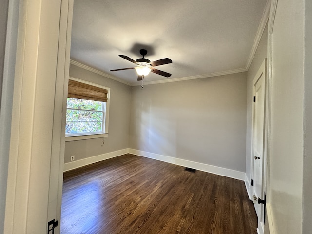 unfurnished room featuring ceiling fan, dark hardwood / wood-style floors, and ornamental molding