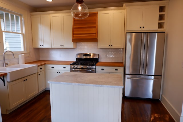 kitchen with white cabinets, stainless steel appliances, and dark wood-type flooring