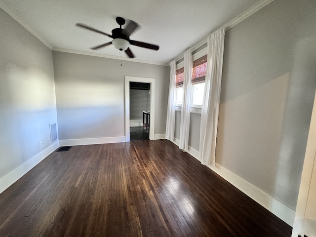 unfurnished room featuring dark hardwood / wood-style flooring, ceiling fan, and crown molding