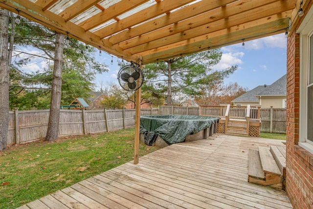 deck featuring a yard and a covered pool