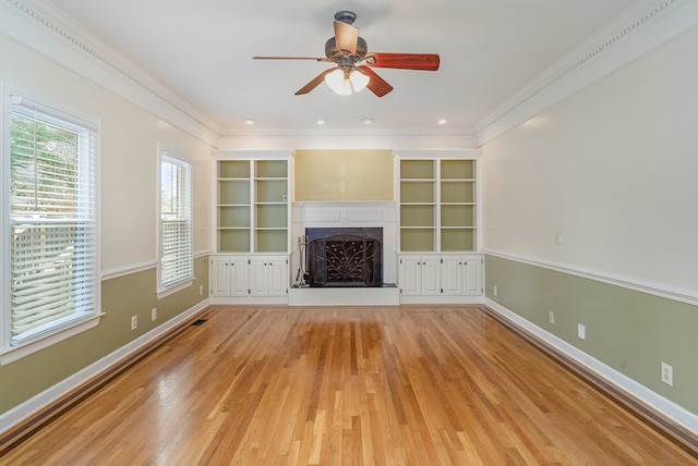 unfurnished living room featuring light hardwood / wood-style floors, ceiling fan, and ornamental molding