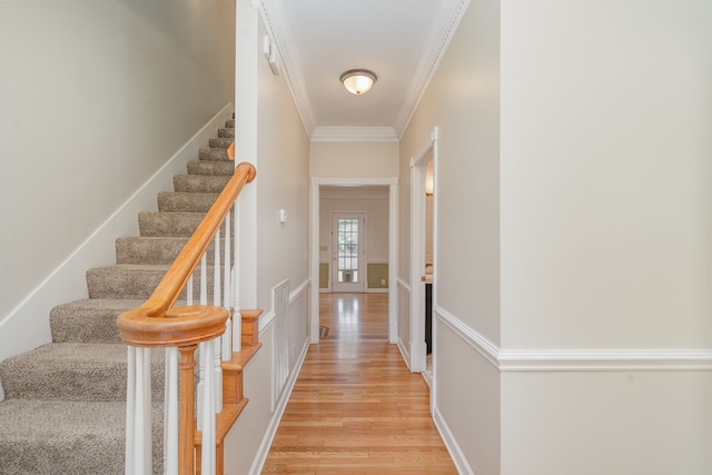 interior space with wood-type flooring and ornamental molding