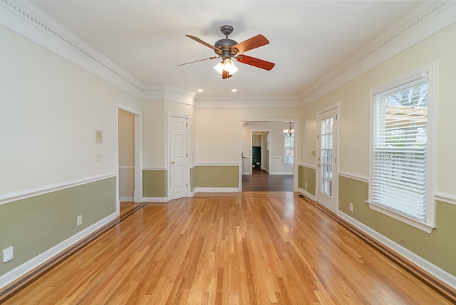 unfurnished room with ceiling fan, ornamental molding, and light wood-type flooring