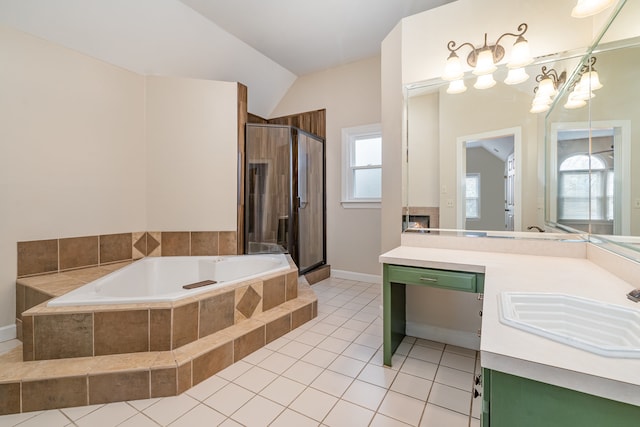 bathroom featuring vanity, lofted ceiling, plus walk in shower, tile patterned flooring, and a tiled fireplace