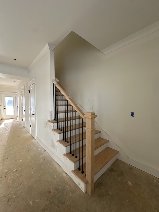 stairs featuring concrete flooring