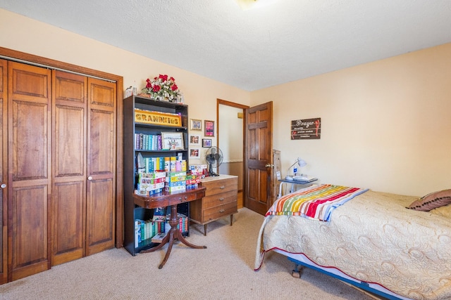 carpeted bedroom featuring a textured ceiling and a closet