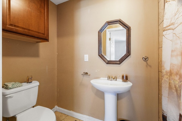 bathroom featuring tile patterned flooring and toilet