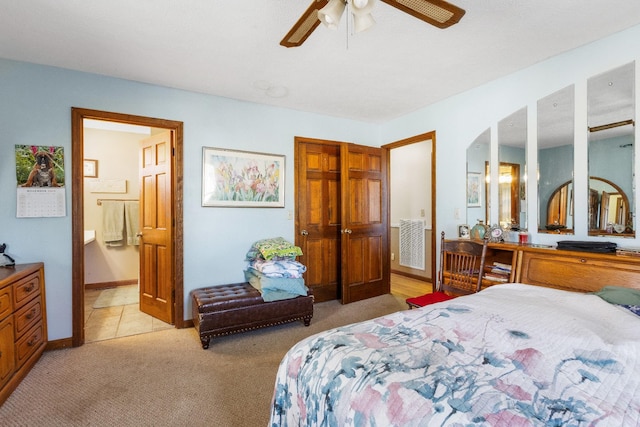 carpeted bedroom featuring ceiling fan and connected bathroom