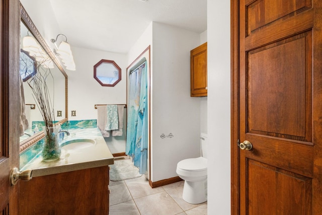 bathroom featuring tile patterned flooring, vanity, and toilet