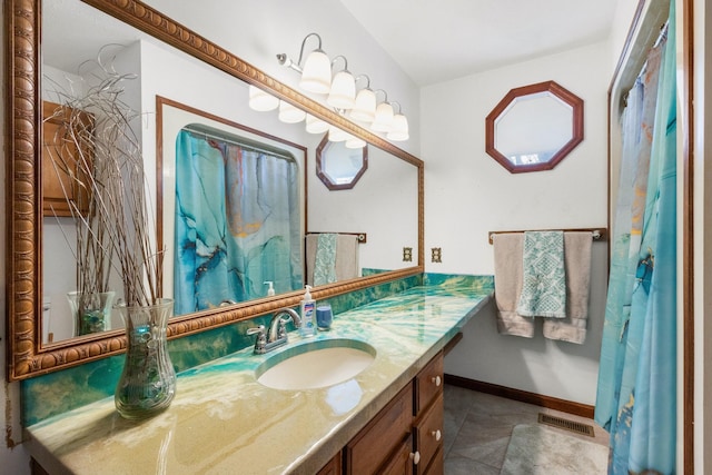 bathroom with tile patterned flooring and vanity