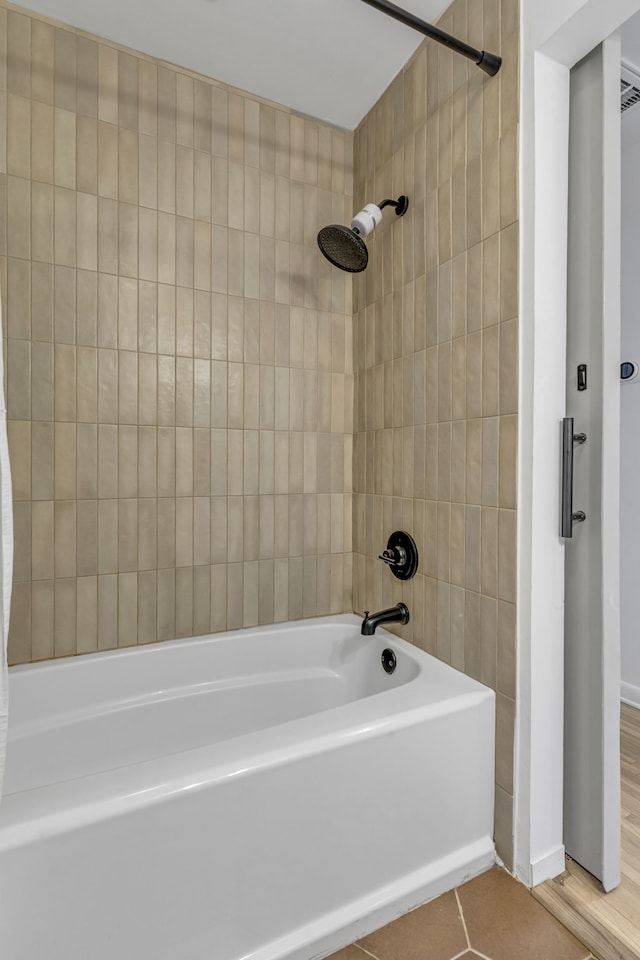 bathroom with tiled shower / bath and hardwood / wood-style flooring