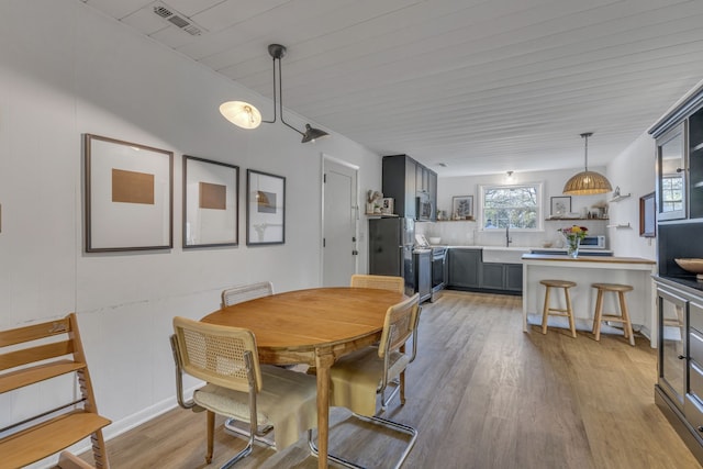 dining room featuring light hardwood / wood-style flooring and sink