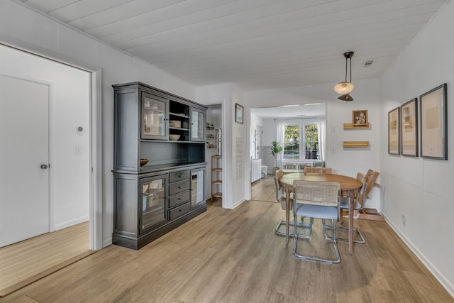 dining room featuring hardwood / wood-style flooring and wood ceiling