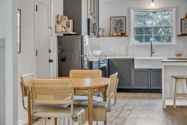 dining space featuring light hardwood / wood-style floors and sink