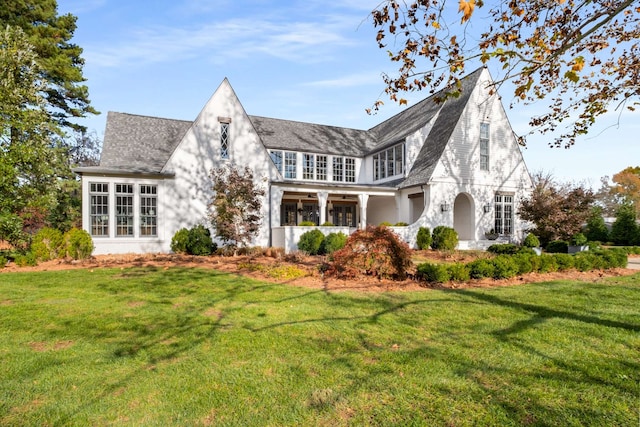 rear view of property with a lawn