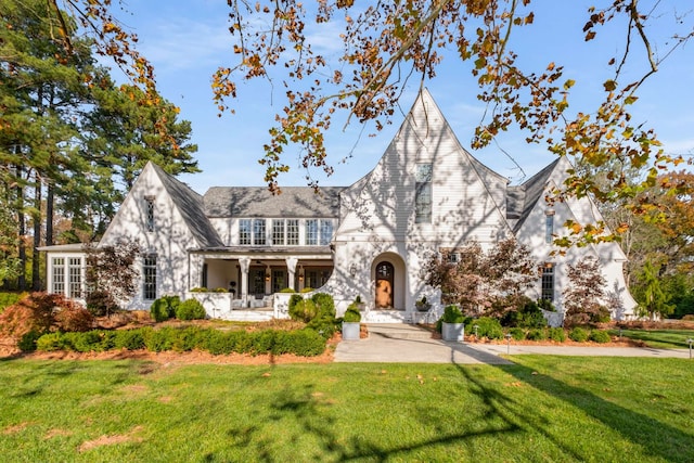 tudor-style house with a front lawn