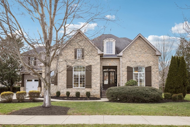 french country home featuring french doors and a front yard