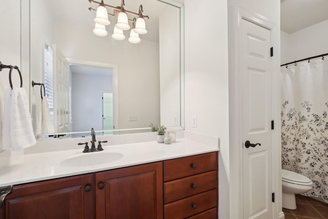 bathroom featuring vanity, toilet, curtained shower, and tile patterned flooring