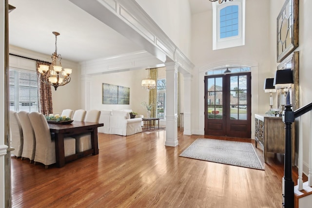 foyer entrance featuring a notable chandelier, hardwood / wood-style flooring, and plenty of natural light